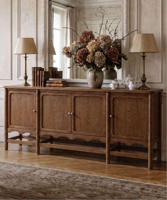 Warm wood sideboard styled with flowers and table lamps